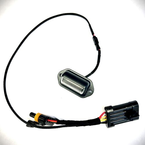 Black LED license plate light with wiring harness connector.
