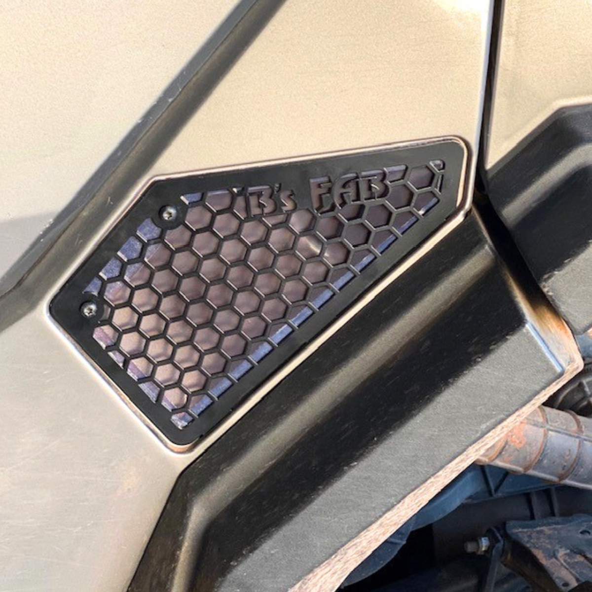 Custom black honeycomb vent with B's FAB logo on vehicle.