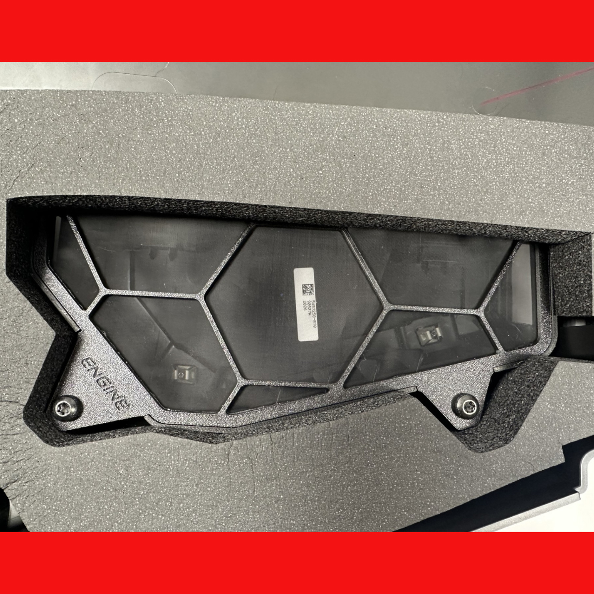 New engine component with hexagonal grille in foam packaging.